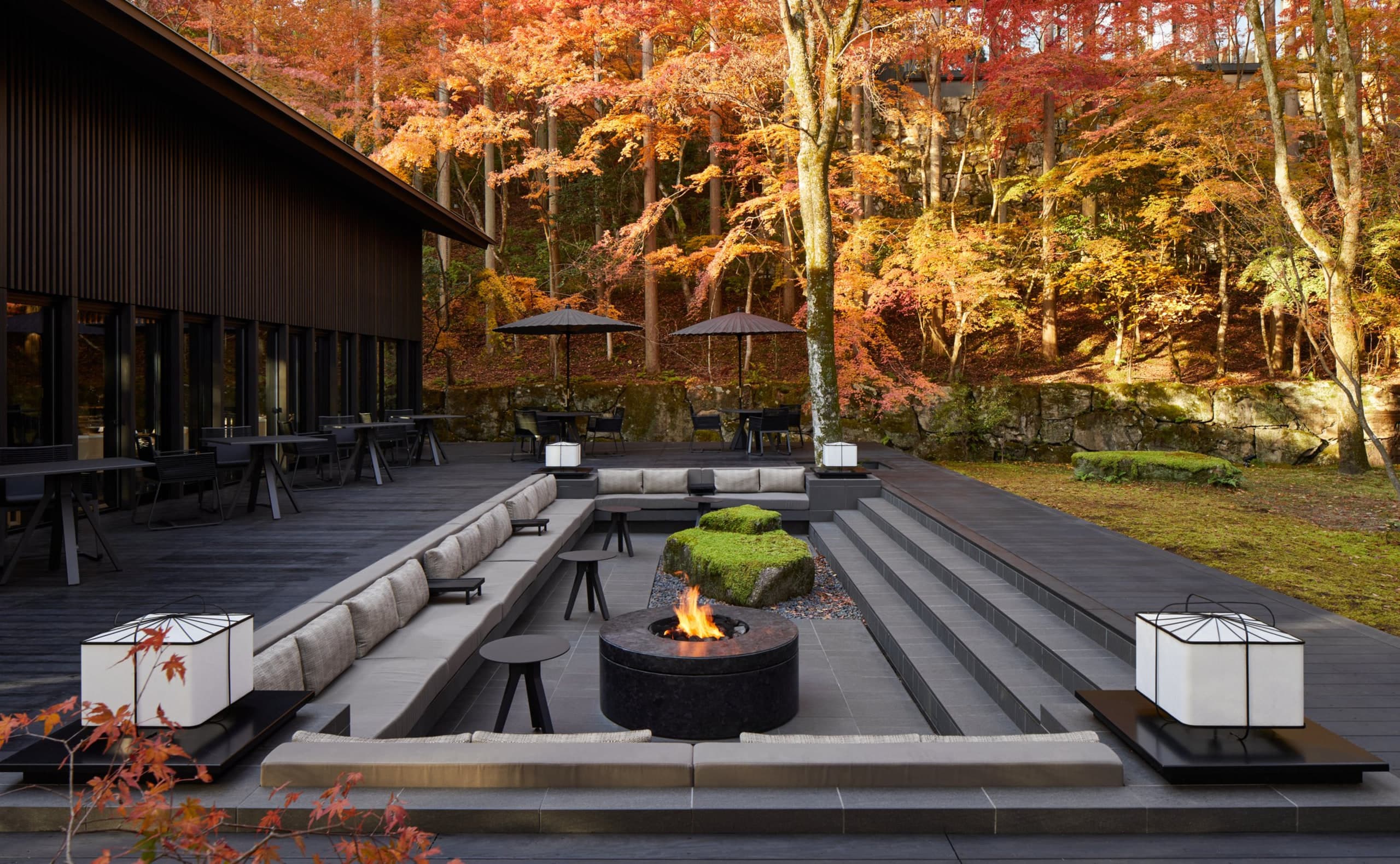 Aman Kyoto Living Pavilion terrace in autumn with sunken lounge, fire pit, timber lattice, and maple hillside