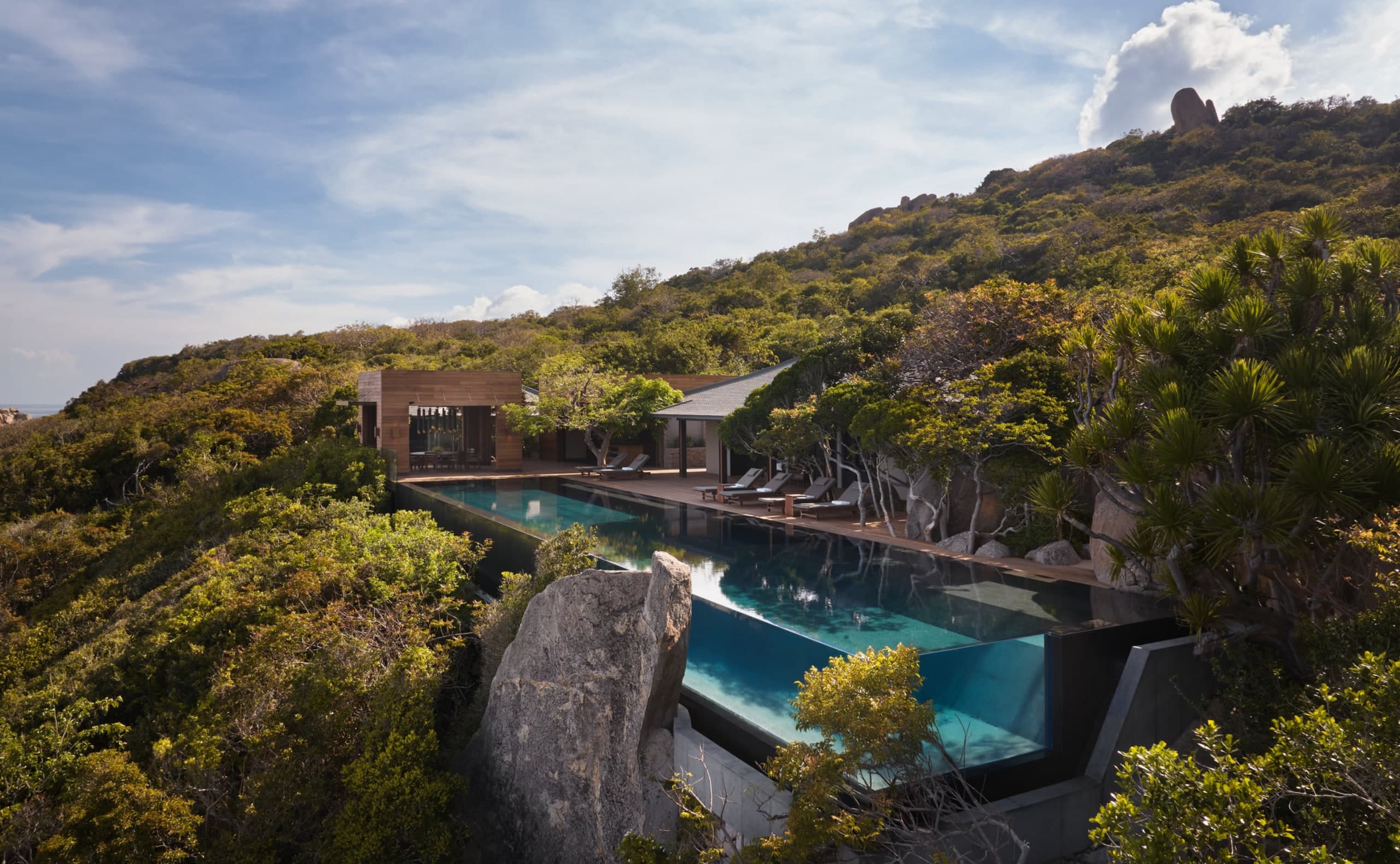 Infinity pool and timber deck of an Amanoi Ocean Pool Residence overlooking Vinh Hy Bay
