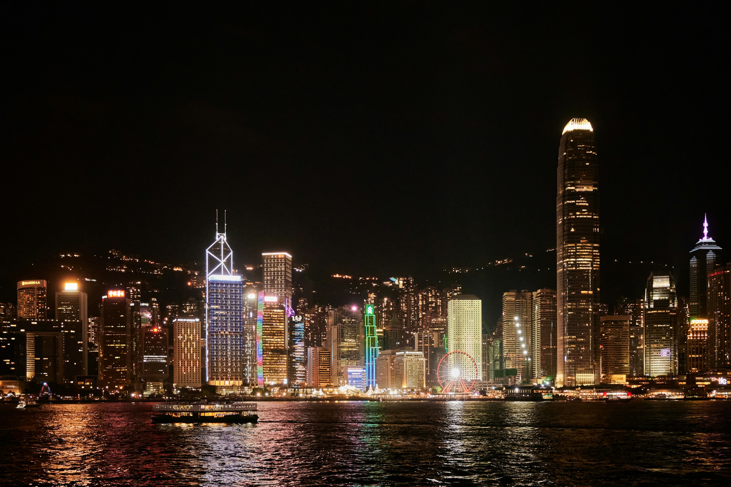 Hong Kong skyline illuminated at night over Victoria Harbour