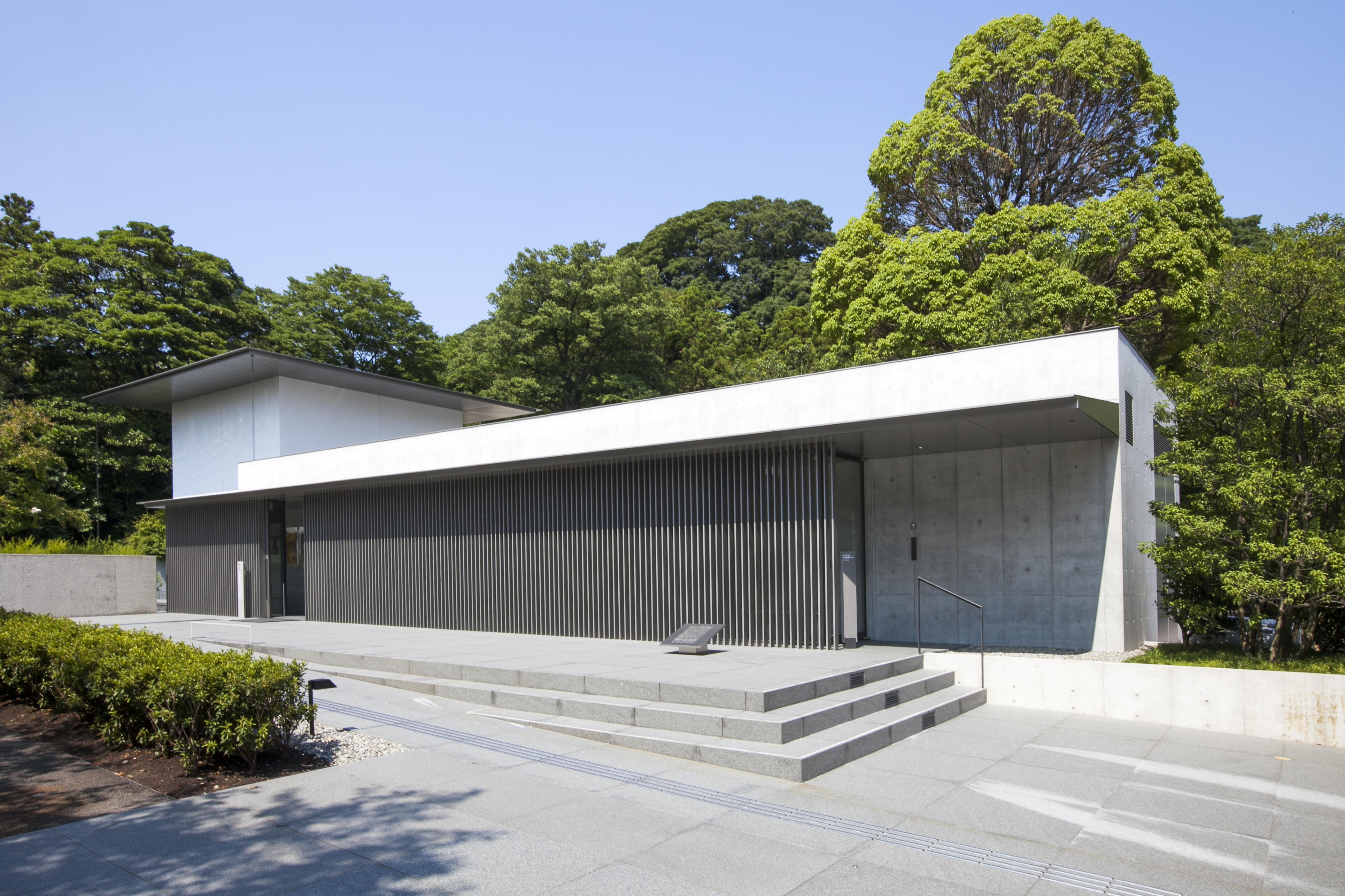 Entrance approach of the D.T. Suzuki Museum against Honda forest greenery